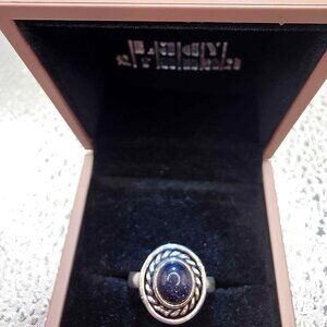 sterling silver boho-style statement ring featuring a dark blue sunstone